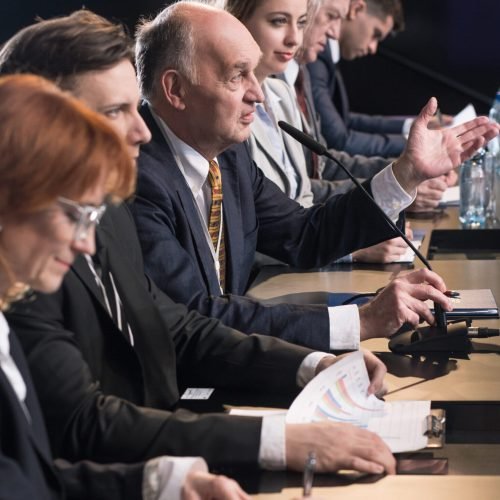 Politicians and journalists taking part in press conference